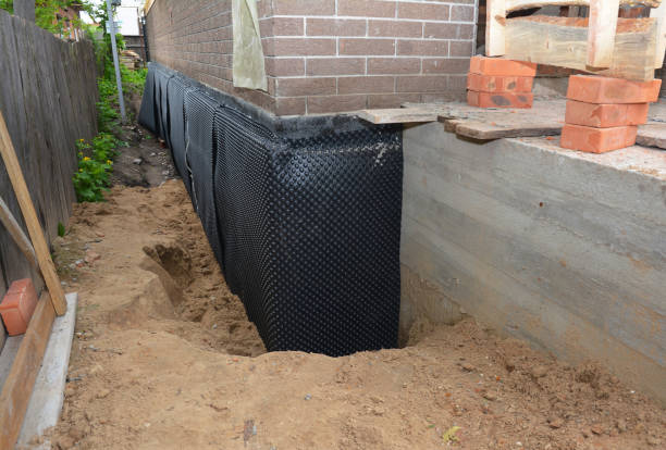 Happy homeowners after waterproofing job in Rudolph